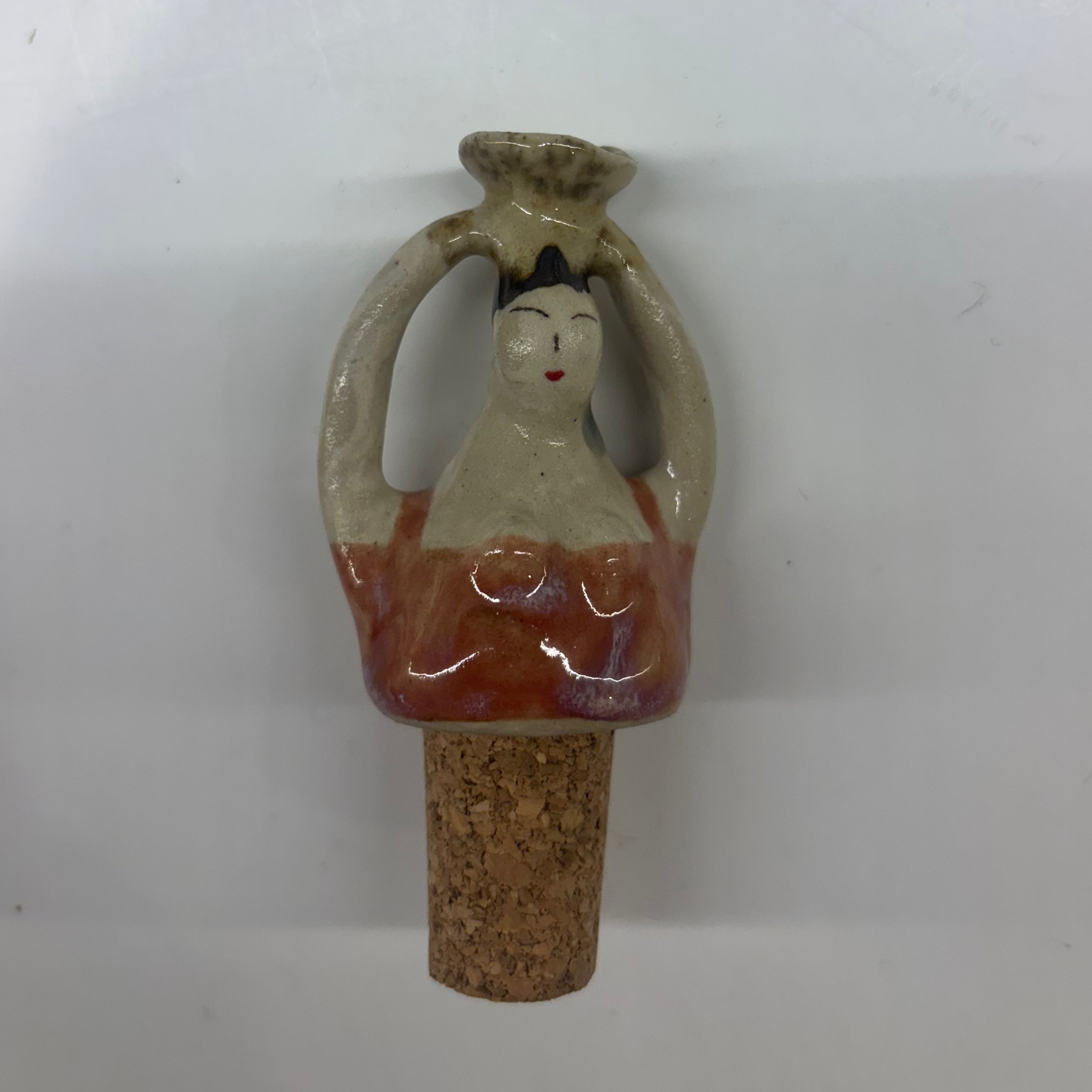 Ceramic bottle stopper with a decorative design on a white background