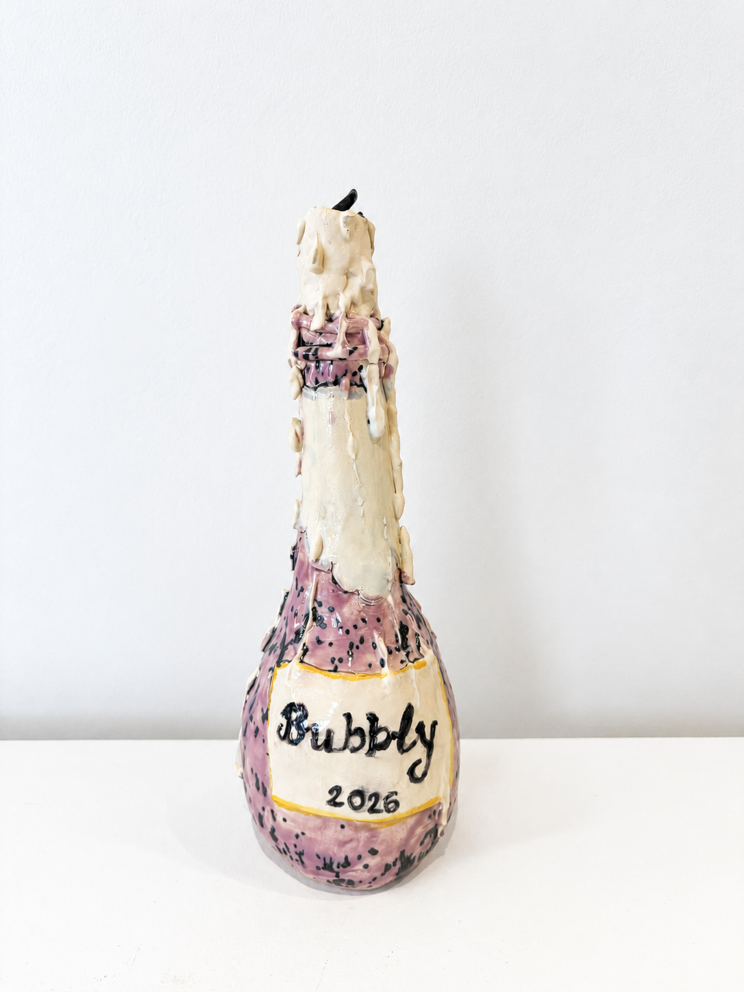 Champagne bottle with drippy candle