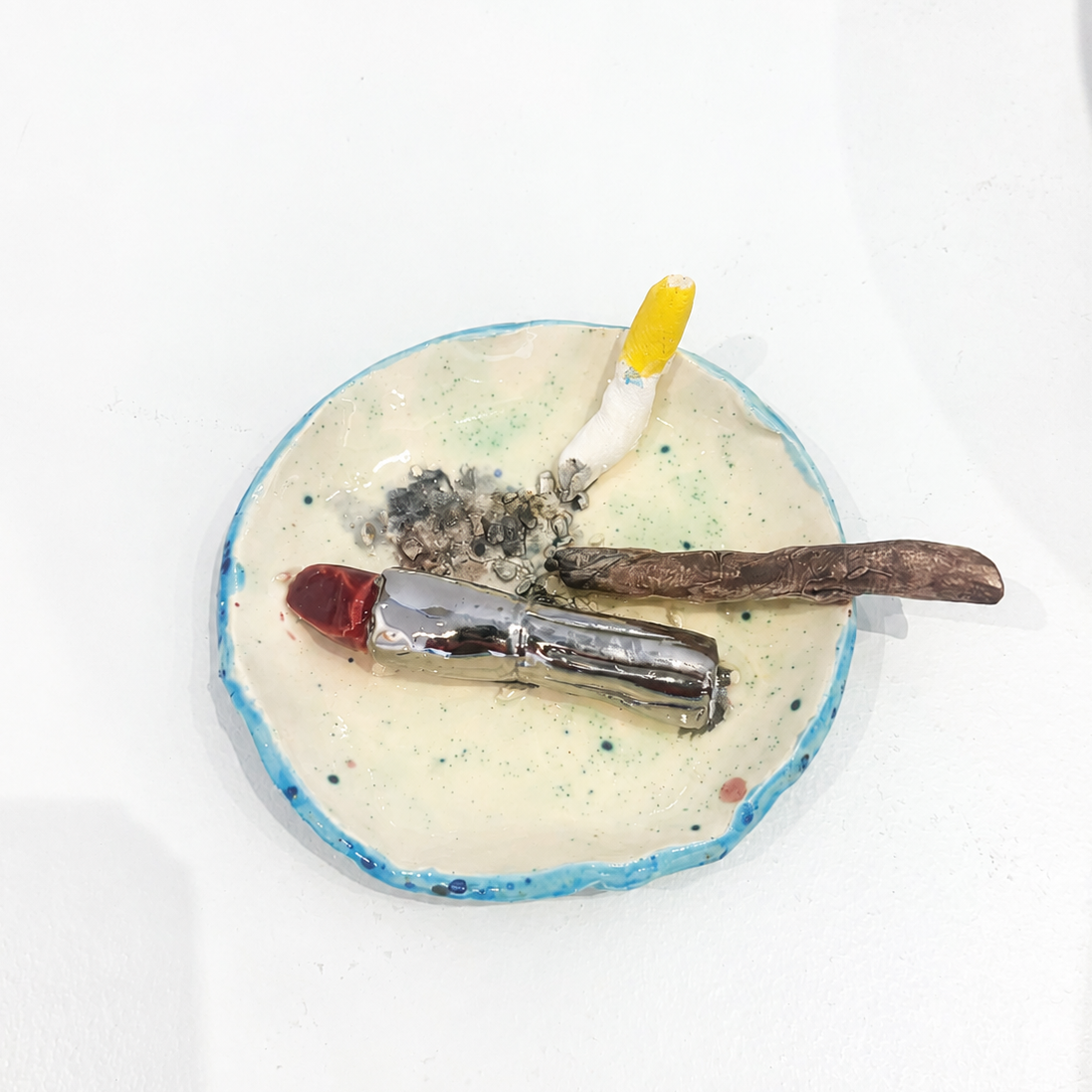 Small ceramic ashtray with lipstick, cigarette, joint