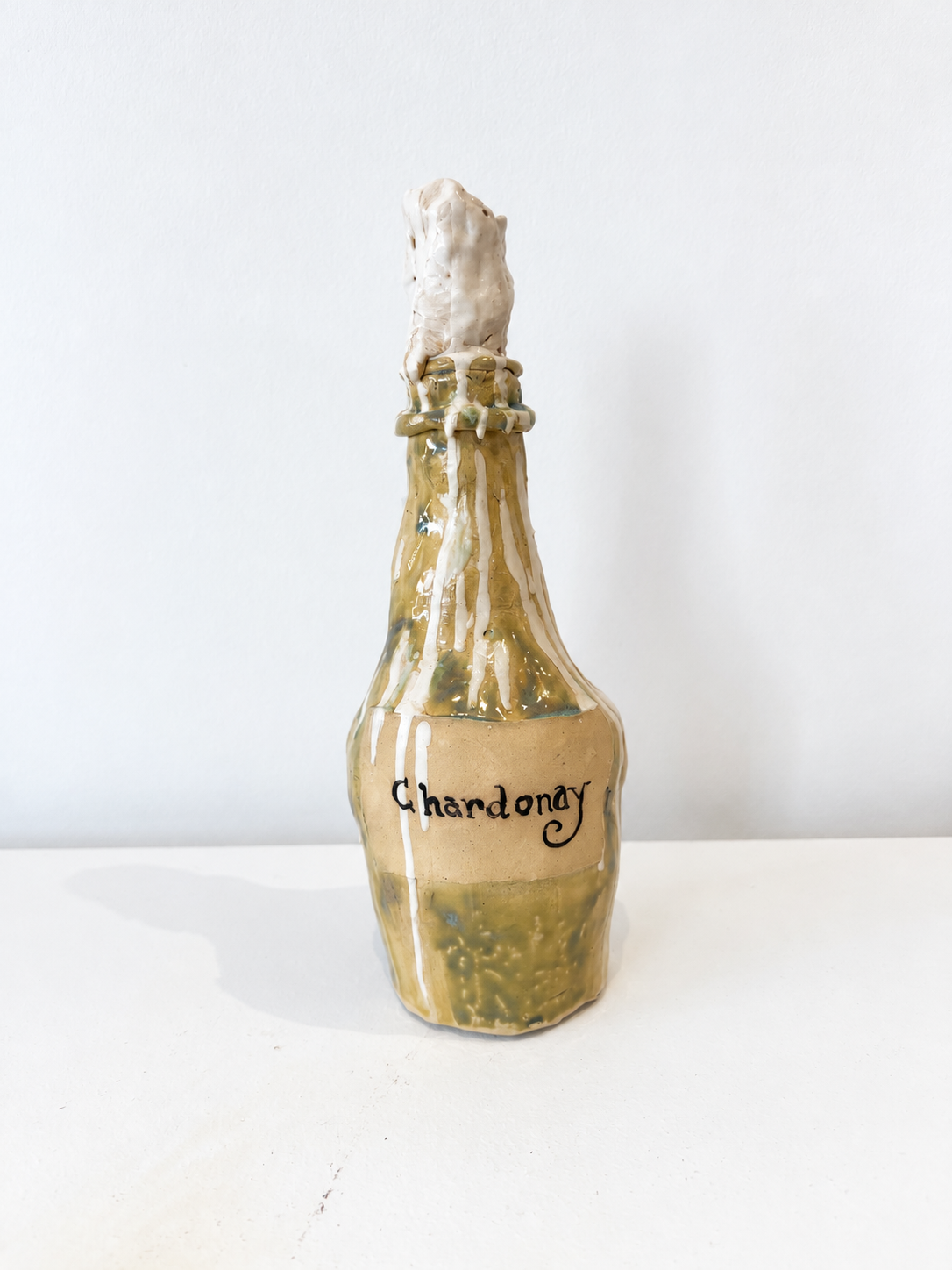 Chardonnay bottle with drippy candle